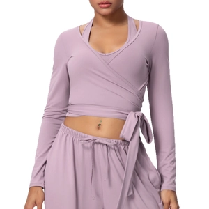 Lilac yoga set featuring long-sleeve wrap top and high-waisted wide-leg athletic pants