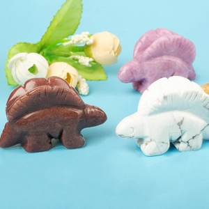 Hand-carved crystal stegosaurus dinosaur statues in brown, white and purple stone