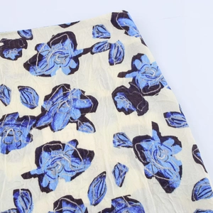 Vintage floral satin midi skirt with blue rose print on cream textured fabric