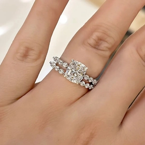 Close-up of cushion cut diamond bridal set in white gold with pavé setting