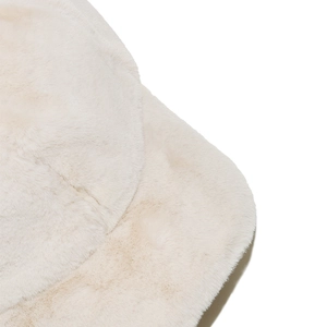 Close-up of white faux rabbit fur texture on a thick winter baseball cap for women
