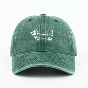 Close-up of a green washed cotton baseball cap featuring a white dachshund embroidery