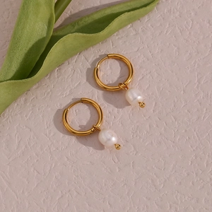 Detail of 18K gold plated hoop earrings featuring elegant freshwater pearl pendants
