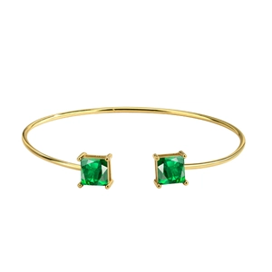Adjustable gold open bangle with two square emerald green crystals on white background