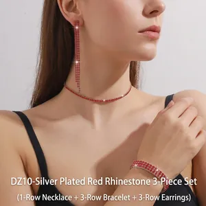 Detail of red rhinestone jewelry set with necklace, wide bracelet and tassel earrings