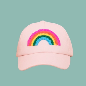 Close-up of pink baseball cap featuring a textured colorful rainbow embroidery patch