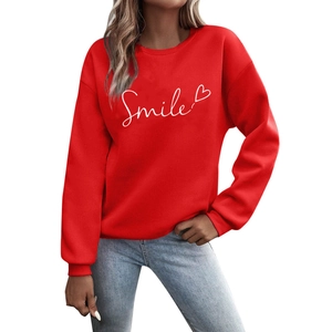 Fashionable red crewneck sweatshirt featuring white Smile text and heart print on cotton