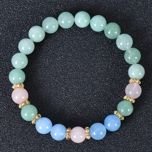 Detail view of multi-color natural stone beads with golden spacers on elastic bracelet