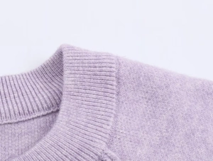 Detail view of lavender knit cardigan showing ribbed neckline and soft wool texture