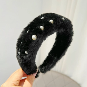 Close-up of black plush headband with white faux pearls and soft mink velvet texture