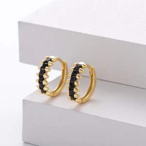 Close-up of golden S925 silver hoop earrings with micro-pave black cubic zirconia stones