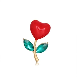 Detail of red enamel heart flower brooch with gold stem and green crystal leaves