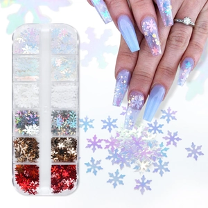 Close-up of 12-grid nail art box with colorful snowflake glitter and holiday manicure application