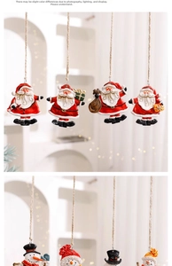 Detail of hand-painted Santa and Snowman ornaments with hanging ropes for Christmas trees