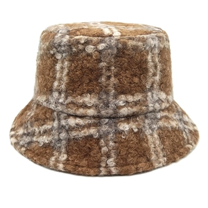Detail of checkered teddy fleece bucket hat in brown and cream warm plush texture
