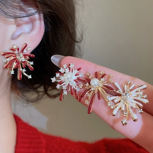 Detail view of fireworks earrings with synthetic pearls, rhinestones, and enamel glaze