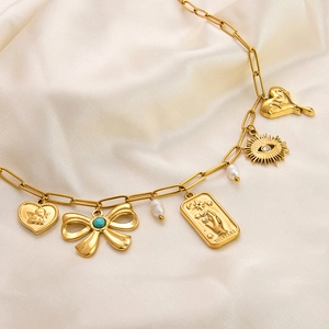 Gold stainless steel tarot charm necklace with sun and heart pendants on silk