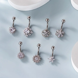 Set of seven stainless steel belly rings with silver flower and snowflake cubic zirconia charms