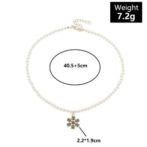 Detail view of pearl Christmas necklace with snowflake charm and size measurements