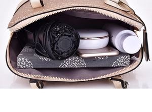 Top view showing the spacious interior compartment of the beige sequined handbag