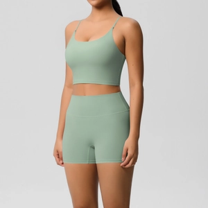 Detail of high-waisted sage green yoga shorts and thin strap sports bra set