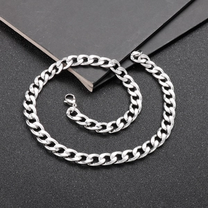 Polished silver stainless steel Cuban link chain necklace for men on black background