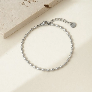Detailed macro of silver stainless steel oval bead chain bracelet with lobster clasp