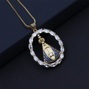 Detail of gold heart pendant with Virgin Mary, marquise stones, and blue crystals