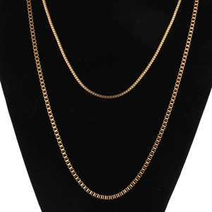 Detail of 2mm golden stainless steel box chain necklace on black jewelry display stand