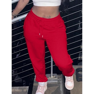Detail view of red joggers featuring an adjustable drawstring waist and elastic cuffs
