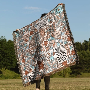 Close-up of Bohemian sun tapestry showing colorful fringe and woven fabric texture