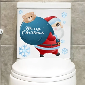 Close-up of Santa Claus and snowflake wall stickers applied on a white toilet lid cover