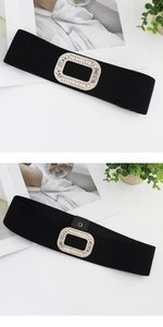 Detail of black elastic waist belt with a rectangular rhinestone buckle and snap closure