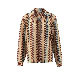 Close-up of wavy knit pattern in brown and beige on a long-sleeved textured shirt