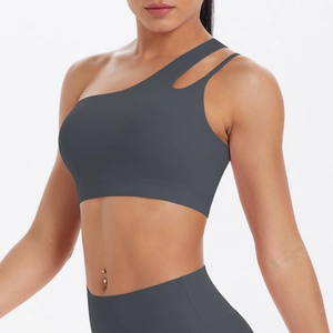 Detail of grey asymmetric one-shoulder sports bra with hollow dual-strap design