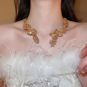 Elegant gold choker featuring champagne teardrop crystals on a fashion model