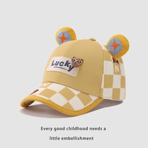 Detail of yellow checkered kids baseball cap with cartoon bear and 3D ears