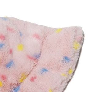 Macro shot of fluffy faux rabbit fur fabric with colorful polka dots on light pink base