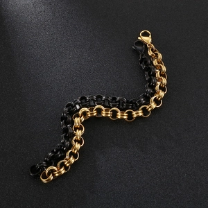Close-up of gold and black stainless steel chunky link chains with lobster clasps on sand