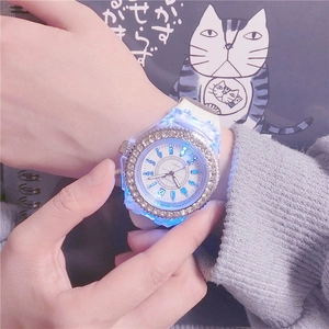 Fashionable women's quartz watch with rhinestone bezel and blue LED backlight on wrist