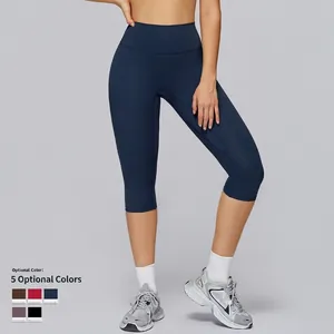 High-waisted navy blue yoga shorts with quick-dry fabric, shown on model in studio
