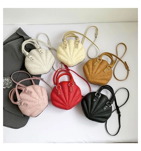 Detailed macro view of multi-color shell-shaped bags with 3D floral embossed texture