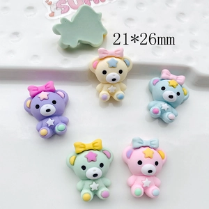 Flat lay of colorful 21x26mm resin bear charms for DIY hair accessories and crafts