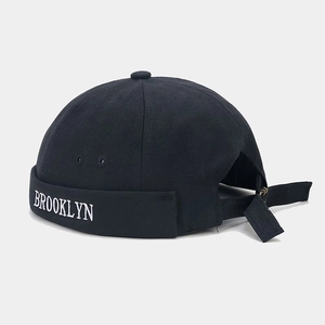 Detail of Brooklyn embroidery on a black cotton docker hat with adjustable back strap