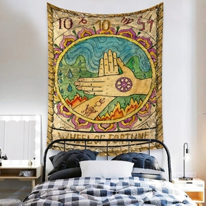 Detail of bohemian Tarot Wheel of Fortune tapestry hanging on a bedroom wall as decor