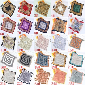 Grid view of 25 assorted 70cm satin square scarves with paisley and geometric prints
