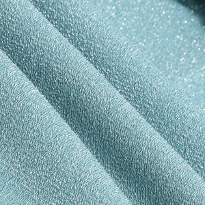 Close-up of light blue knit fabric with silver metallic glitter thread and soft texture