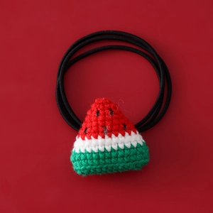 Detailed macro of handmade crochet watermelon hair tie with high elastic band for girls