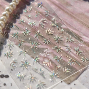 Detailed holographic bamboo leaf nail stickers with metallic finish on transparent sheet