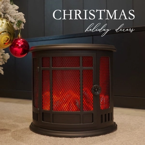 Black vintage LED fireplace lantern with flame effect near a Christmas tree